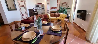 a dining room with a wooden table and chairs at Note di Palermo Loft in Palermo
