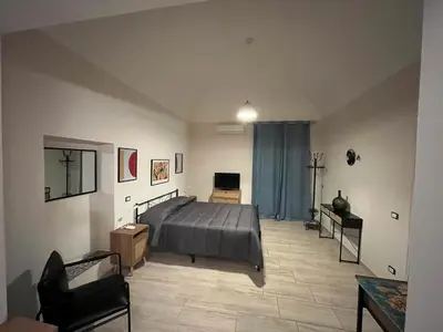 a bedroom with a bed and a television in it at Donna Maria in Cinisi