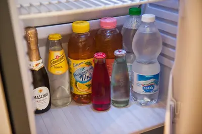 a refrigerator filled with lots of bottles of drinks at Accussì rooms in San Vito lo Capo