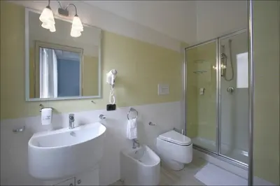 a bathroom with a sink and a shower and a toilet at Accussì rooms in San Vito lo Capo