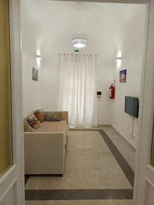 a living room with a couch and a television at Le meraviglie di Palermo Casa Vacanze Holiday House in Palermo