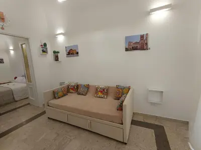 a living room with a couch with pillows on it at Le meraviglie di Palermo Casa Vacanze Holiday House in Palermo