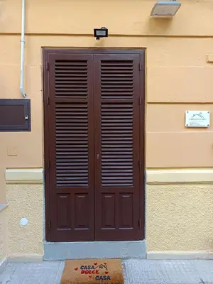 a brown door on the side of a building at Le meraviglie di Palermo Casa Vacanze Holiday House in Palermo