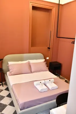 a bedroom with a bed with two towels on it at Mamamia #Teatro Biondo in Palermo