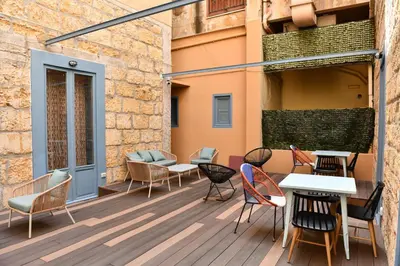 a patio with chairs and tables on a building at Mamamia #Teatro Biondo in Palermo