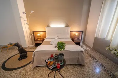 a bedroom with a bed and a dog sitting on the floor at La zagara di Alba in Palermo
