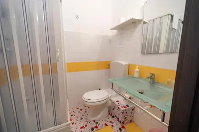 a bathroom with a toilet and a sink at La zagara di Alba in Palermo