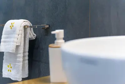 a bathroom with a white towel hanging next to a sink at Le Margherite in San Vito lo Capo