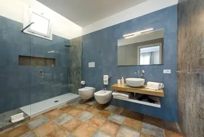 a bathroom with two toilets and a shower at Le Margherite in San Vito lo Capo