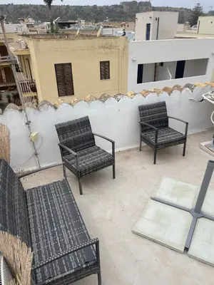 two benches sitting on top of a roof at nanzi u mare in San Vito lo Capo