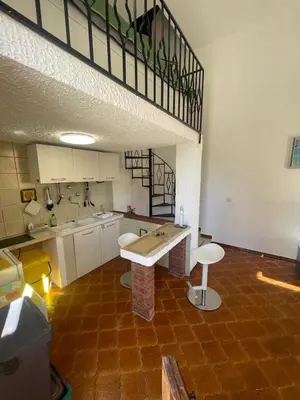 a kitchen with a table in the middle of a room at nanzi u mare in San Vito lo Capo