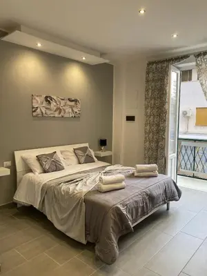 a bedroom with a large bed with two towels on it at CASE VACANZE FraEmily , PALERMO in Palermo