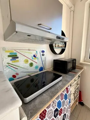 a kitchen with a counter top with a stove top oven at Sea Pearl House in Isola delle Femmine