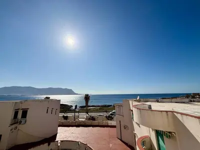 a view of the ocean from between two buildings at Sea Pearl House in Isola delle Femmine