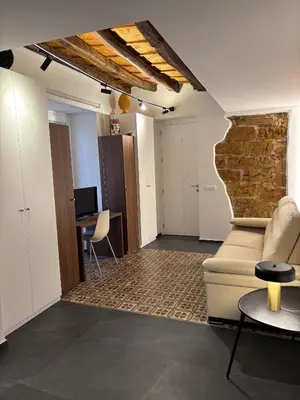 a living room with a couch and a brick wall at Casa delle Maioliche in Palermo