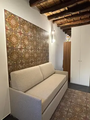 a couch in a room with a wall at Casa delle Maioliche in Palermo