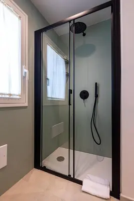a shower with a glass door in a bathroom at Villa Dafni Private Pool & Relax near Cefalù in Campofelice di Roccella