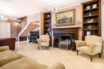 a living room with a fireplace and a piano at Villa Bouganville in Monreale