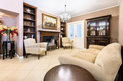 a living room with a couch and a fireplace at Villa Bouganville in Monreale
