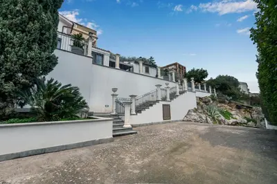 a building with stairs on the side of it at Villa Bouganville in Monreale