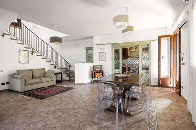 a living room with a table and a couch at Villa Zagara Swimming Pool and Seaview in Ficarazzi