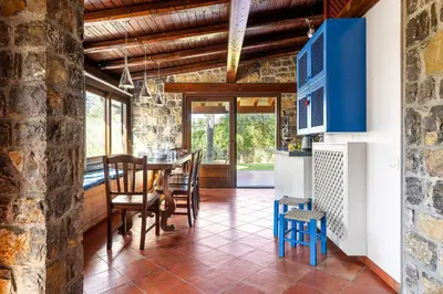 a kitchen and dining room with a table and chairs at Villa Zagara Swimming Pool and Seaview in Ficarazzi