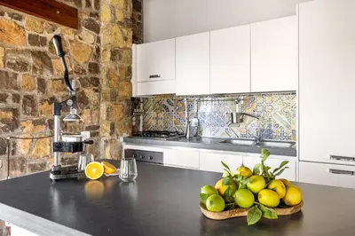 a kitchen with a bowl of fruit on a counter at Villa Zagara Swimming Pool and Seaview in Ficarazzi