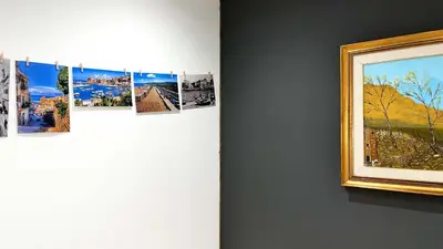 a group of photographs hanging on a wall next to a painting at SILVIO'S Apartment in Castellammare del Golfo