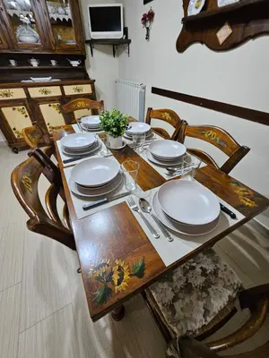a wooden table with plates and utensils on it at La Casa Di Ady in Palermo