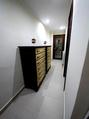 a hallway with a chest of drawers and a hallway with a door at La Casa Di Ady in Palermo