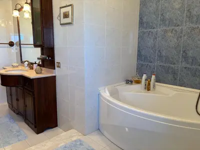 a bathroom with a white tub and a sink at Appartamento Vista Golfo in Castellammare del Golfo