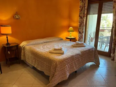 a bedroom with a bed with two towels on it at Appartamento Vista Golfo in Castellammare del Golfo
