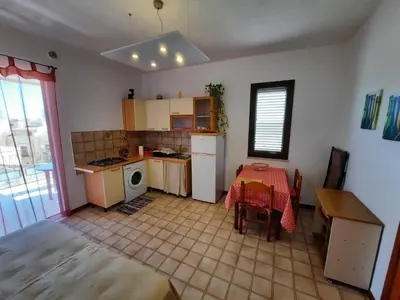 a kitchen with a small table and a kitchen with a table and a tableablish at Appartamento vista mare in Castellammare del Golfo
