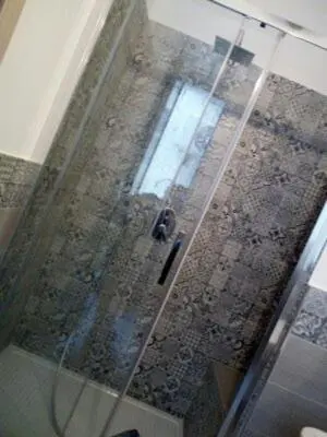 a shower with a glass door in a bathroom at Dai Mori in Lascari