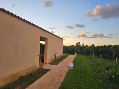 a brick walkway next to a building in a field at Casale Morillo in Campofelice di Roccella