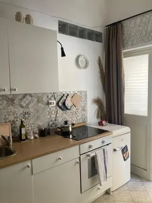 a kitchen with a sink and a stove top oven at Casteldaccia Stay, mieszkanko Kingi in Casteldaccia