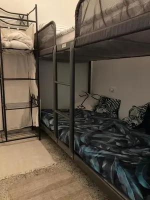 two bunk beds in a room with a bed at Casteldaccia Stay, mieszkanko Kingi in Casteldaccia