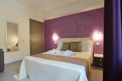 a bedroom with a large bed with towels on it at Le Falesie di Castelluzzo in Castelluzzo