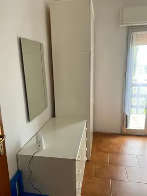 a white dresser in a room with a mirror at Scopello Beach in Scopello