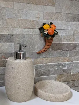 a soap dispenser on a wall with a flower vase at Villa with private pool and wonderful view in Carini