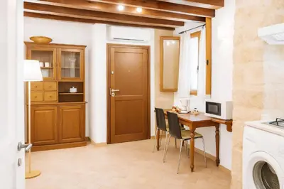 a kitchen and dining room with a table and chairs at Damiani Case Vacanze Palermo - Centro Storico in Palermo