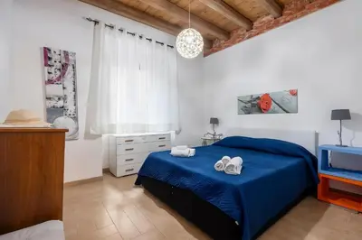 a kitchen with a table and chairs and a door at Damiani Case Vacanze Palermo - Centro Storico in Palermo