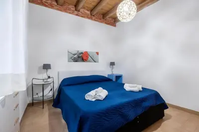 a bedroom with a wooden closet and a table at Damiani Case Vacanze Palermo - Centro Storico in Palermo