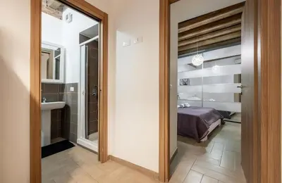 a bedroom with a large white bed with two towels at Damiani Case Vacanze Palermo - Centro Storico in Palermo