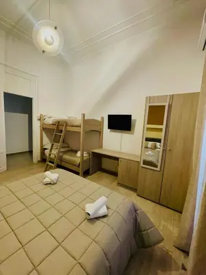 a bedroom with a bed and a bunk bed and a tv at Alberto1 in Palermo