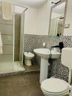 a bathroom with a toilet and a sink and a shower at Alberto1 in Palermo