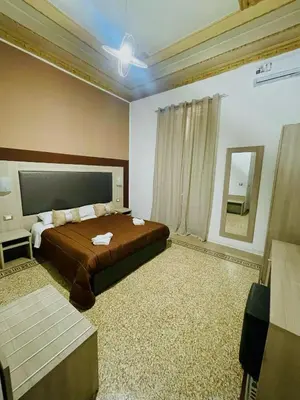 a bedroom with a large bed and a mirror at Alberto1 in Palermo