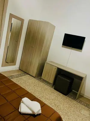 a room with two wooden cabinets and a flat screen tv at Alberto1 in Palermo