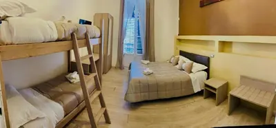 a small room with bunk beds and a bed at Alberto1 in Palermo