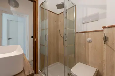 a bathroom with a shower and a toilet and a sink at Kadì Apartment by Wonderful Italy in Palermo